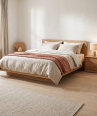 Bedroom with oak bed and terracotta throw