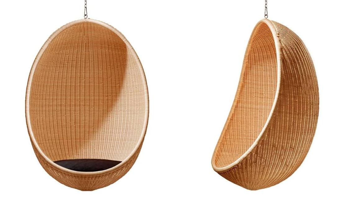 Two hanging rattan swing chairs with dark cushions